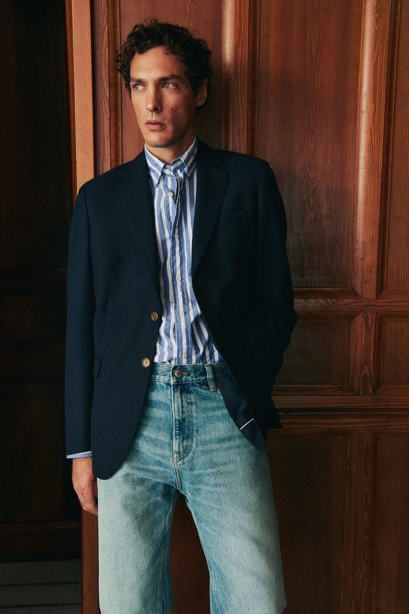 Pierre-Benoit Talbourdet dons a GANT striped poplin shirt with a navy blazer and distressed jeans. 