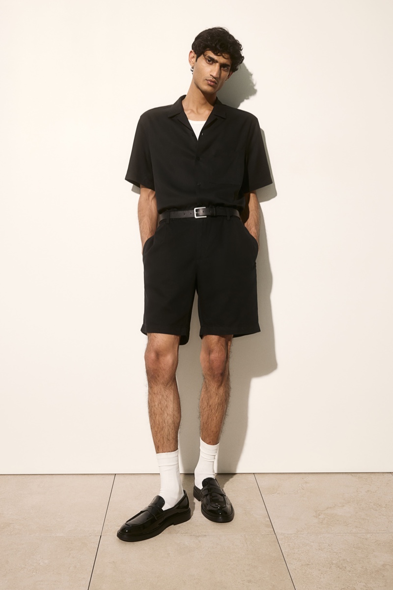 Model Neeraj Saini sports an H&M short-sleeve shirt with linen-blend shorts to make a case for black and white.