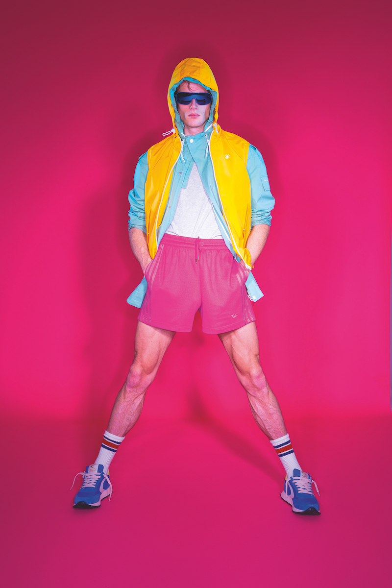 Hugh wears nylon vest and jacket Manuel Ritz, t-shirt SUN68, shorts adidas Originals, sneakers Valsport, and sunglasses Polaroid.