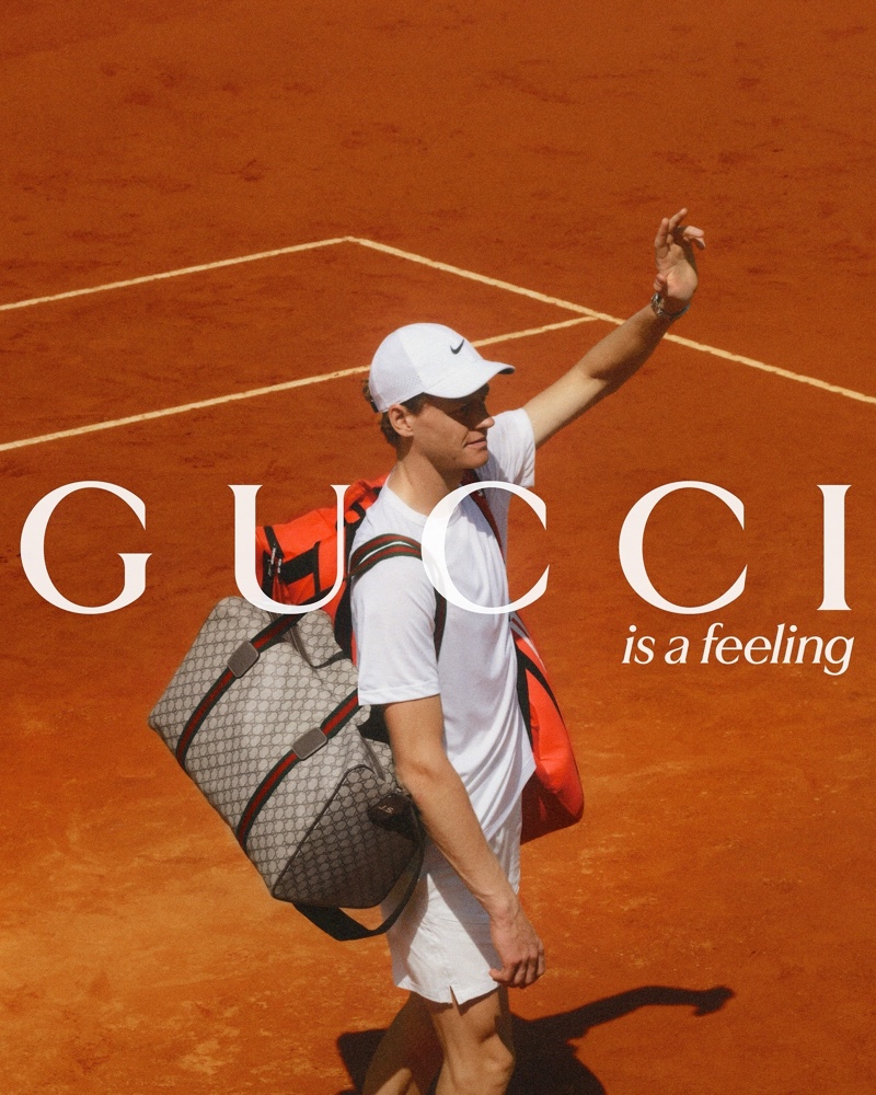 Jannik Sinner fronts the Gucci is a Feeling campaign, carrying the brand's bags, such as the GG Supreme canvas holdall bag.