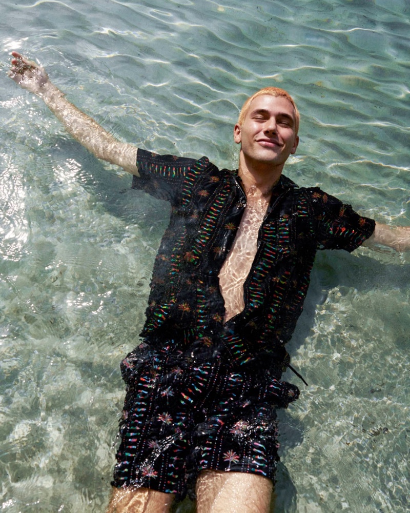 Enjoying a summer dip, Julio Taeño sports a matching shirt and shorts set from Scotch & Soda.