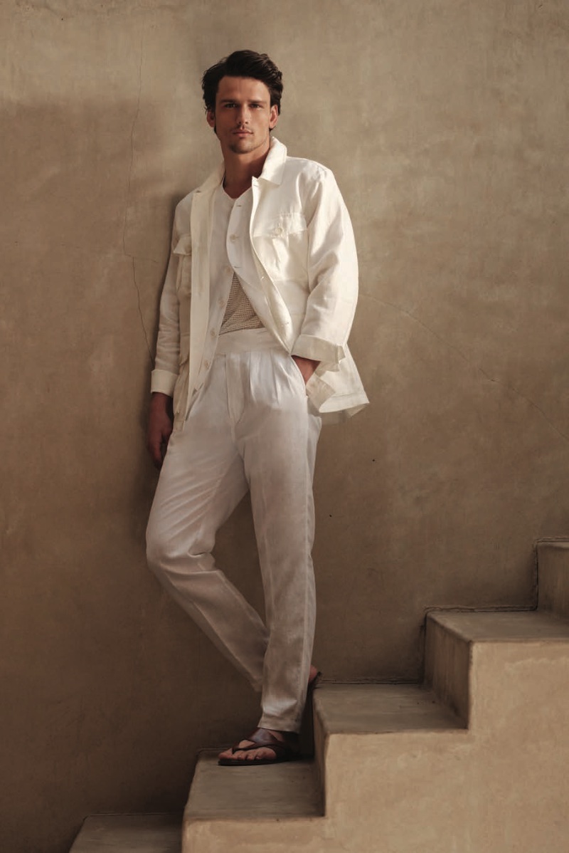 Wearing all white, Simon Nessman dons an Irish linen field jacket and vest with Gurkha trousers and leather cross sandals.