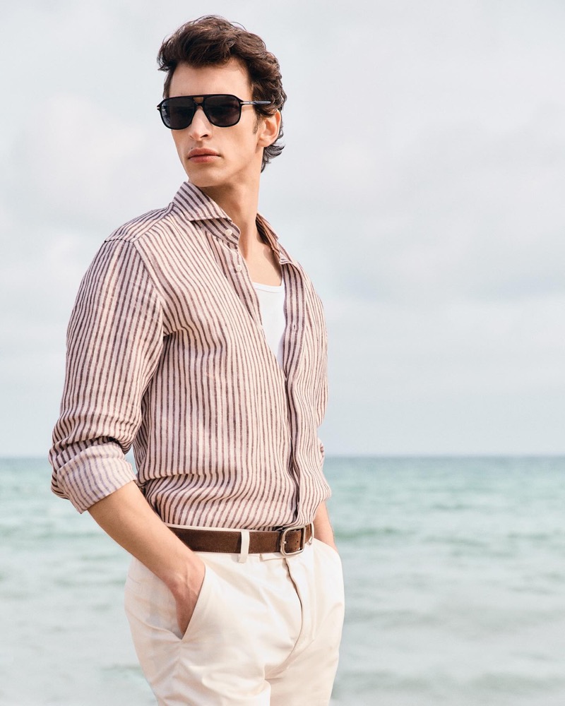 Habib Masovic wears BOSS navigator-style sunglasses with gold-tone trims. » BOSS Eyewear Sets a Chic Summer Scene by the Beach Habib Masovic wears BOSS navigator-style sunglasses with gold-tone trims.