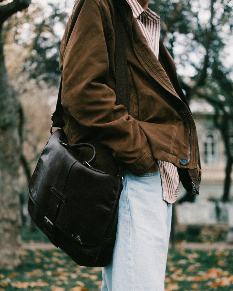 A leather messenger bag pairs with casual layers, showing how everyday essentials can carry both purpose and lasting style. » 12 Leather Goods for Men That Add Style to the Everyday A leather messenger bag pairs with casual layers, showing how everyday essentials can carry both purpose and lasting style.