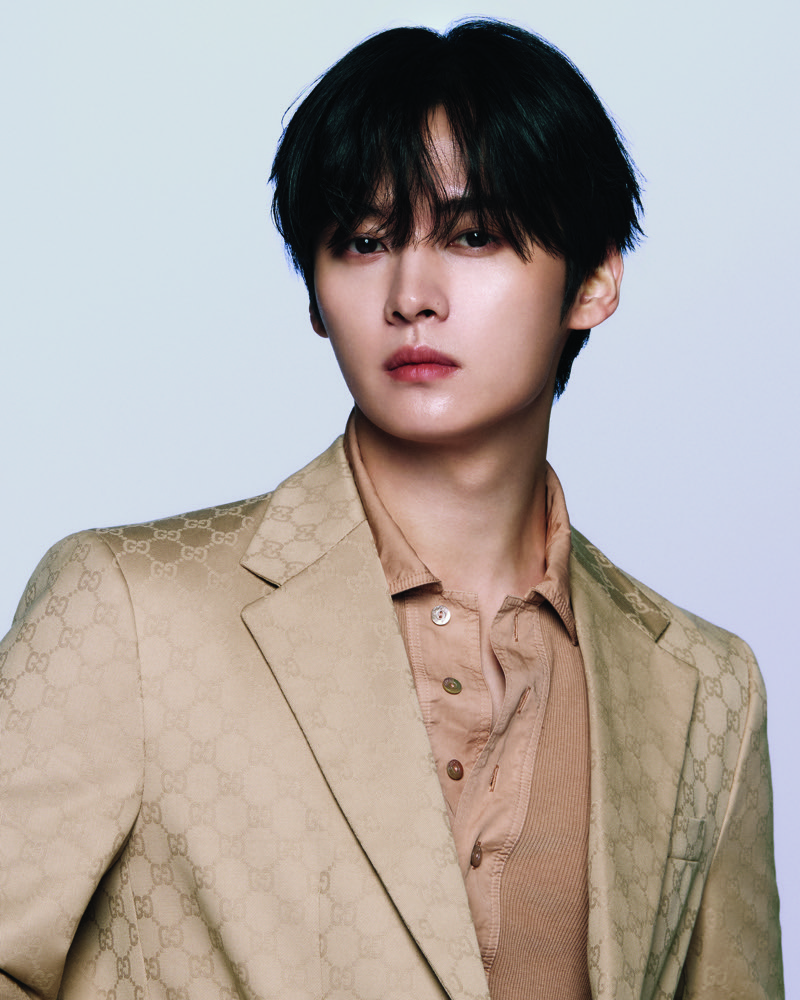 Lee Know wears monogram tailoring as Gucci's newest global brand ambassador. 