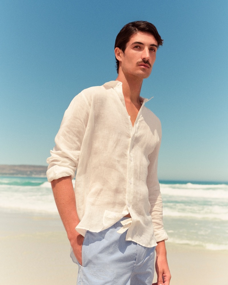 Romain Beziau wears a chic summer look with Orlebar Brown's white linen tailored-fit shirt and gingham drawcord shorts. » Orlebar Brown Summer 2025 Taps Into Sun-Soaked Nostalgia Romain Beziau wears a chic summer look with Orlebar Brown's white linen tailored-fit shirt and gingham drawcord shorts.