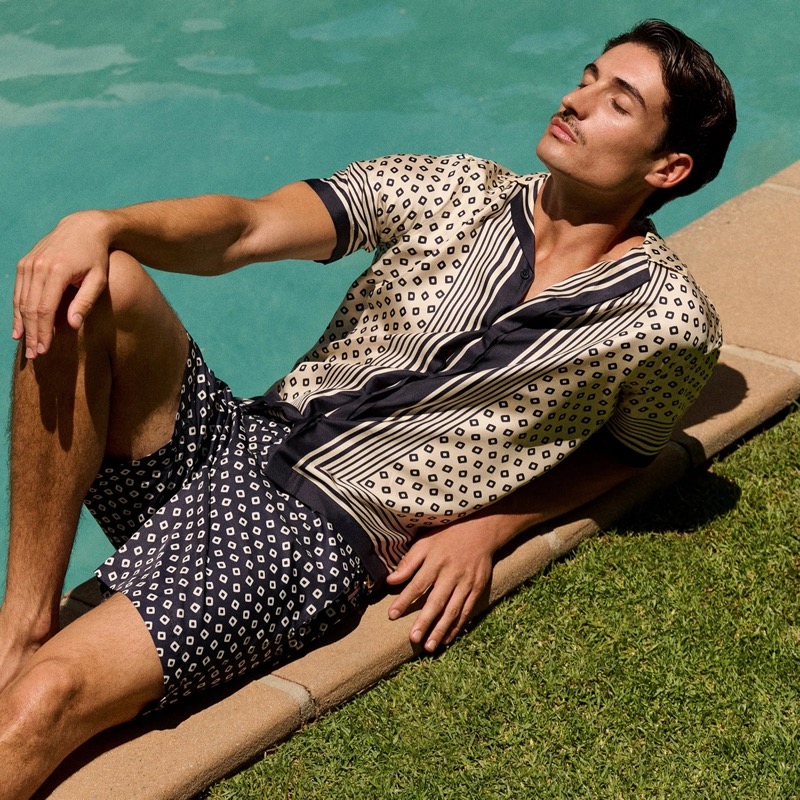The Maitan silk capri collar shirt infuses the season with luxury, paired with Orlebar Brown's signature Bulldog swim shorts. » Orlebar Brown Summer 2025 Taps Into Sun-Soaked Nostalgia The Maitan silk capri collar shirt infuses the season with luxury, paired with Orlebar Brown's signature Bulldog swim shorts.