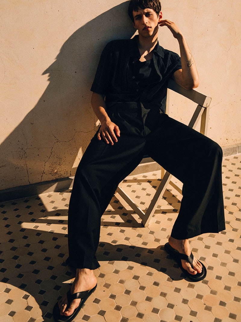 Rokas Kavaliauskas wears an all-black look from COS's high summer 2025 collection. 