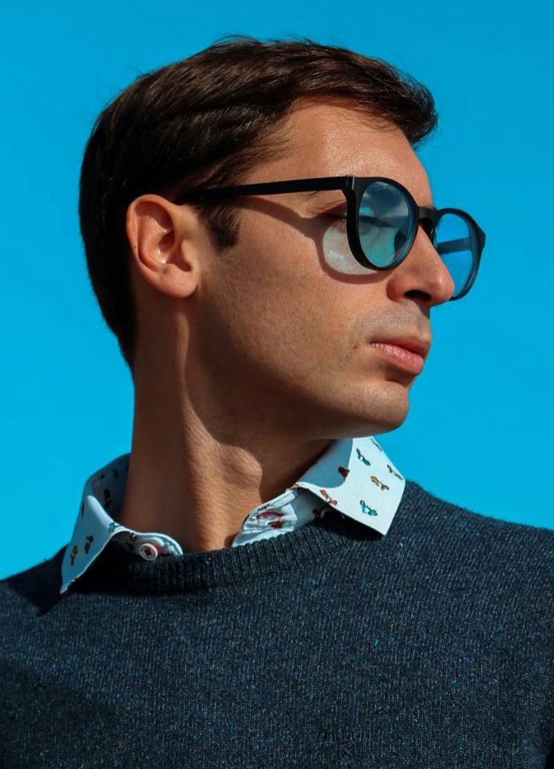 man wearing round sunglasses with blue lenses