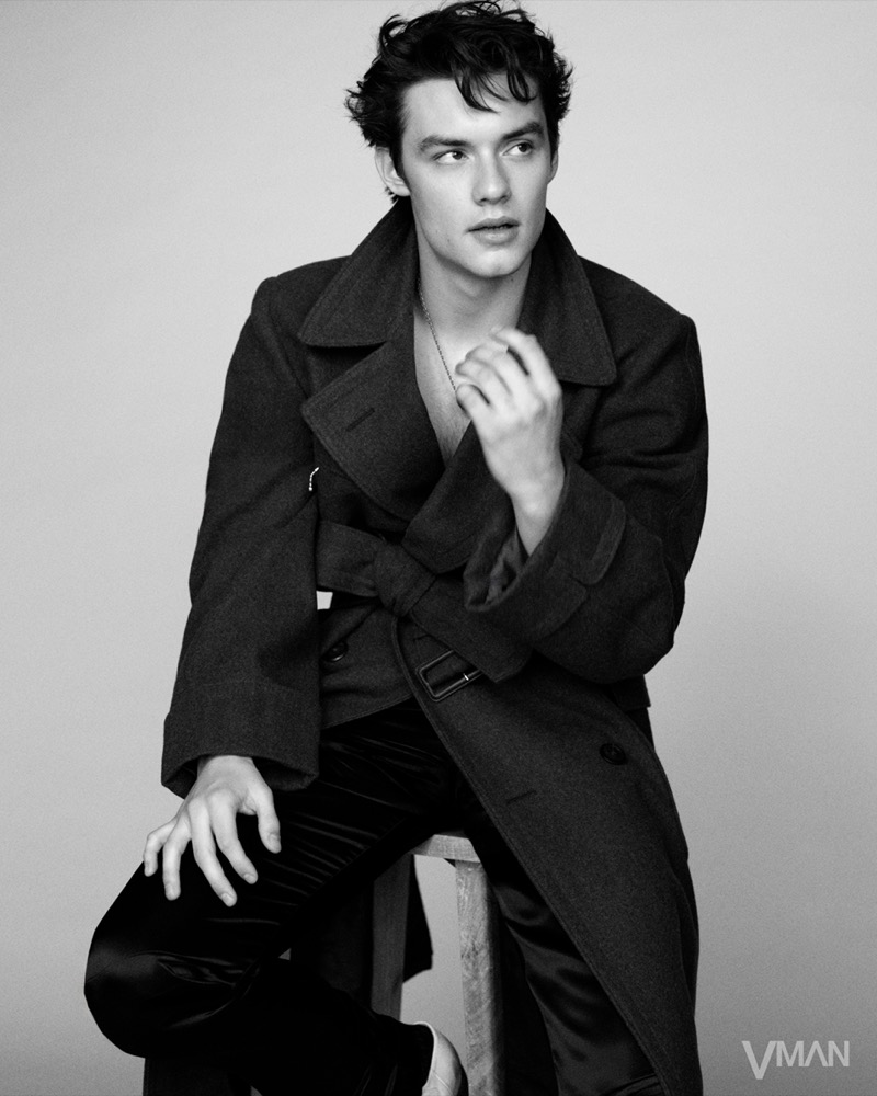 Louis Partridge wears a belted Prada trench for VMAN.