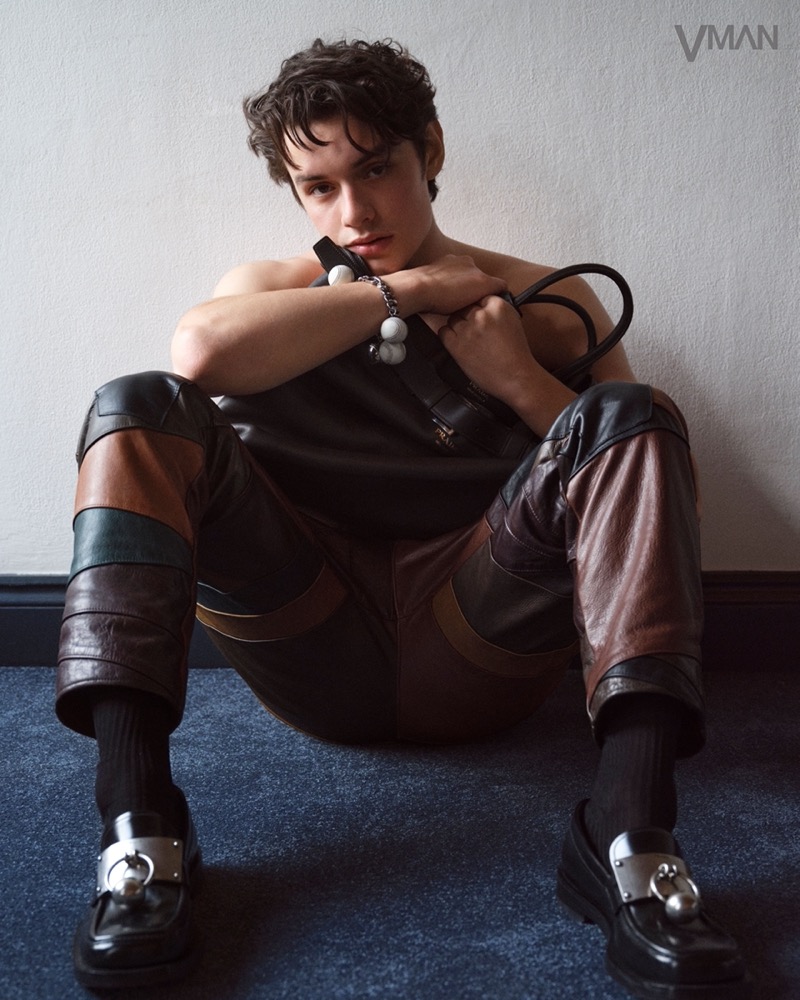 Louis Partridge wears a leather outfit by Prada.
