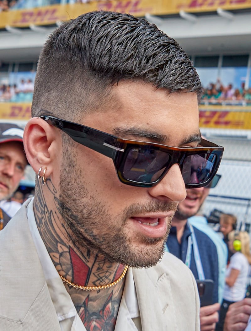 Zayn Malik with a soft fade haircut and textured top with natural separation.