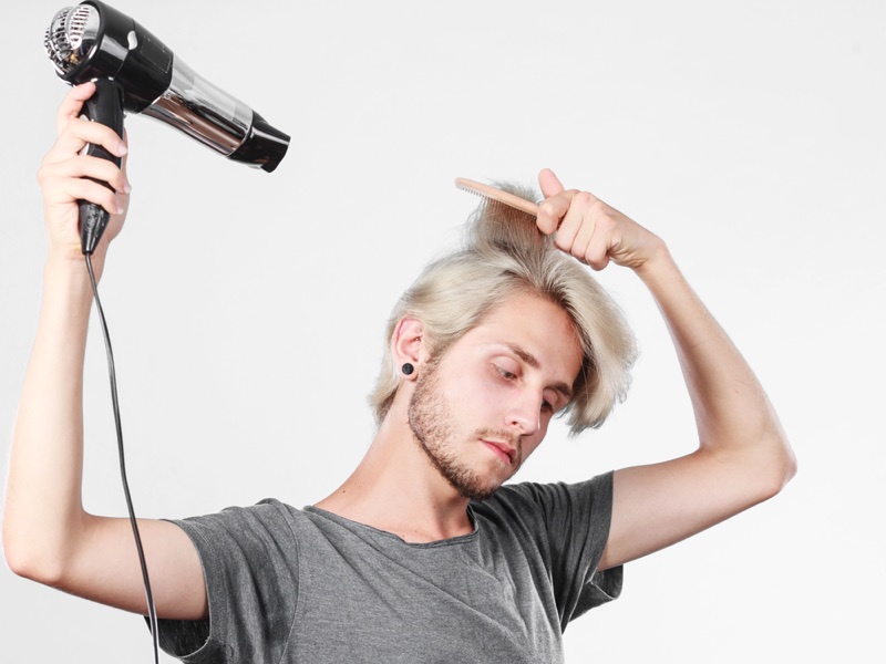 Blond man hair dryer