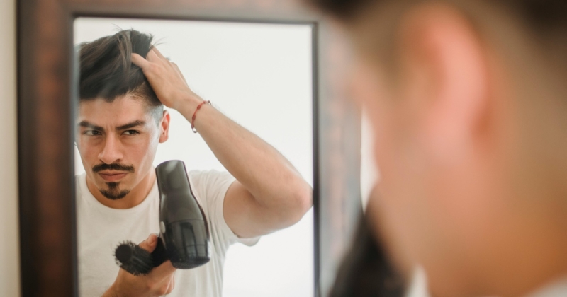 Man blowdrying hair mirror featured