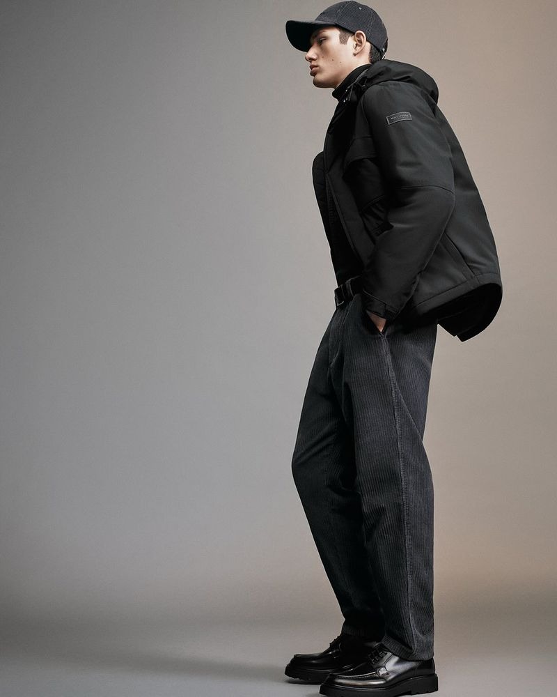 Luka wears a Marc O'Polo jacket with a corduroy cap and pants over leather boots
