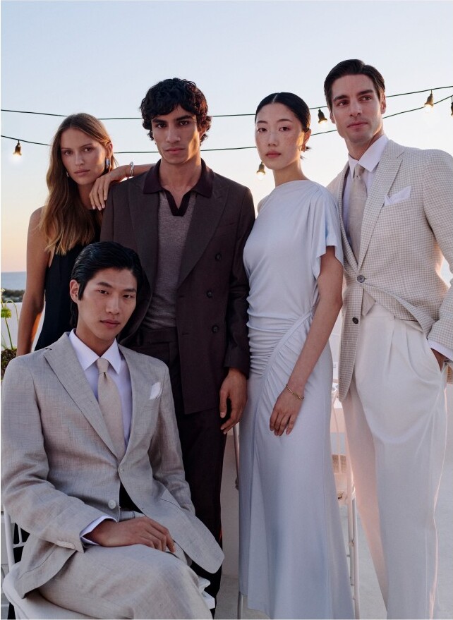 Models pose as a wedding party in neutral-colored outfits