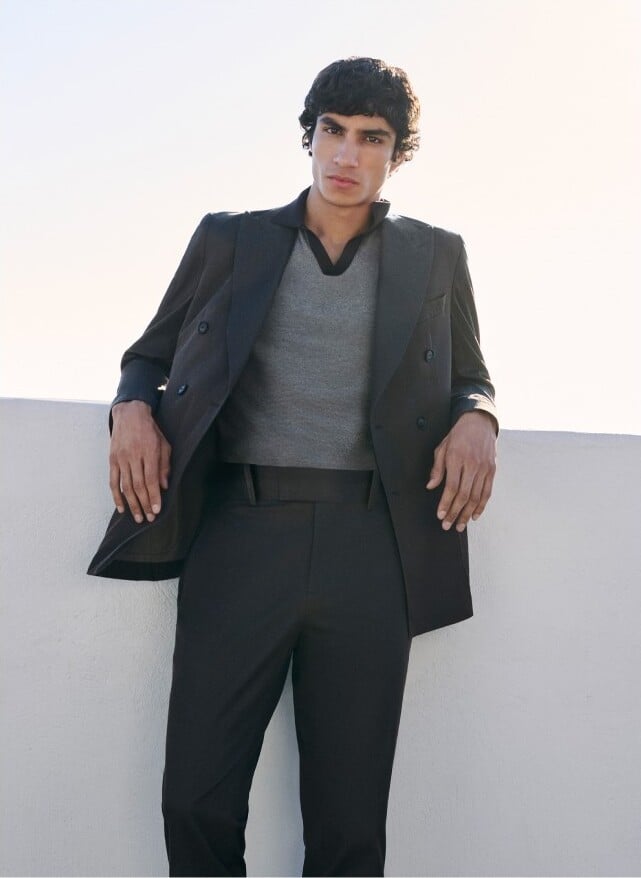 Duncan wears a Johnny collar polo with a double-breasted suit