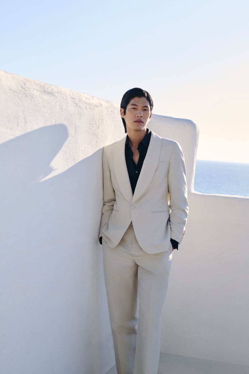 Sanggun wears a beige tuxedo over a black dress shirt