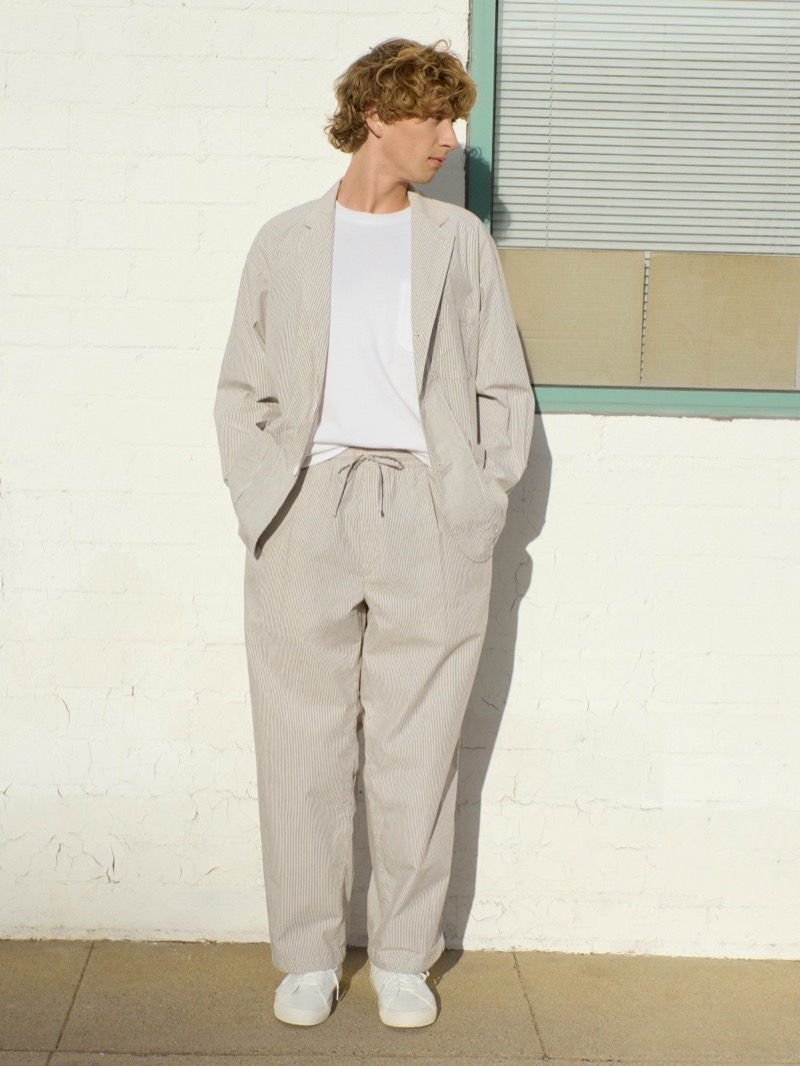 Model wears oversized cordlane suit with a pocket tee