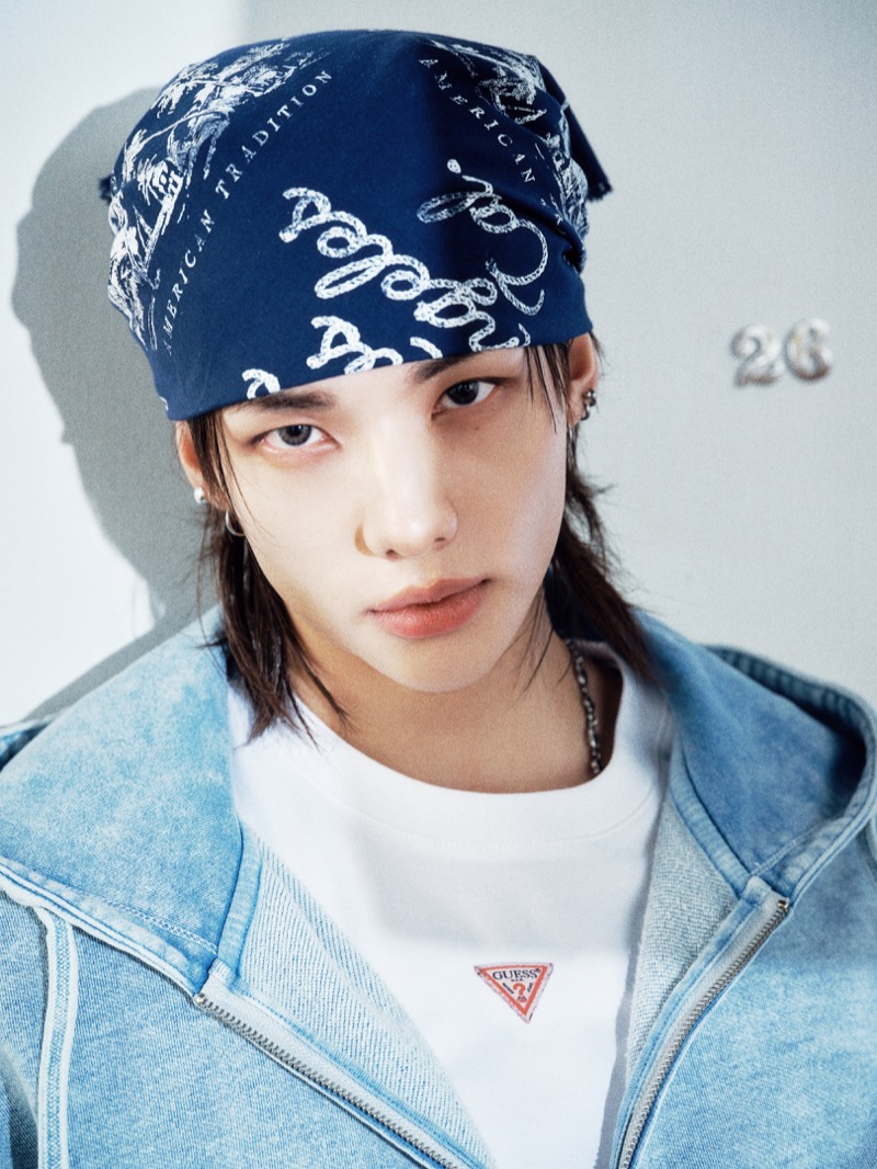 Hyunjin wears a blue bandana with a hoodie and GUESS logo T-shirt