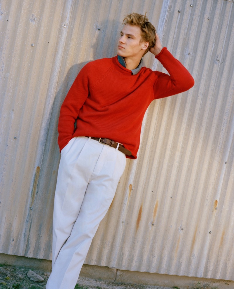 Model poses in a red rollneck with corduroy trousers from J.Crew