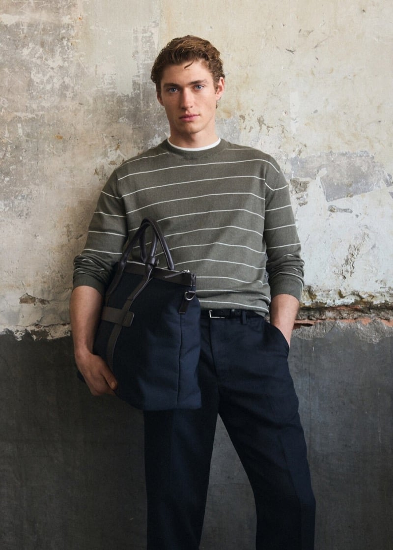 Valentin wears a striped sweater with belted trousers