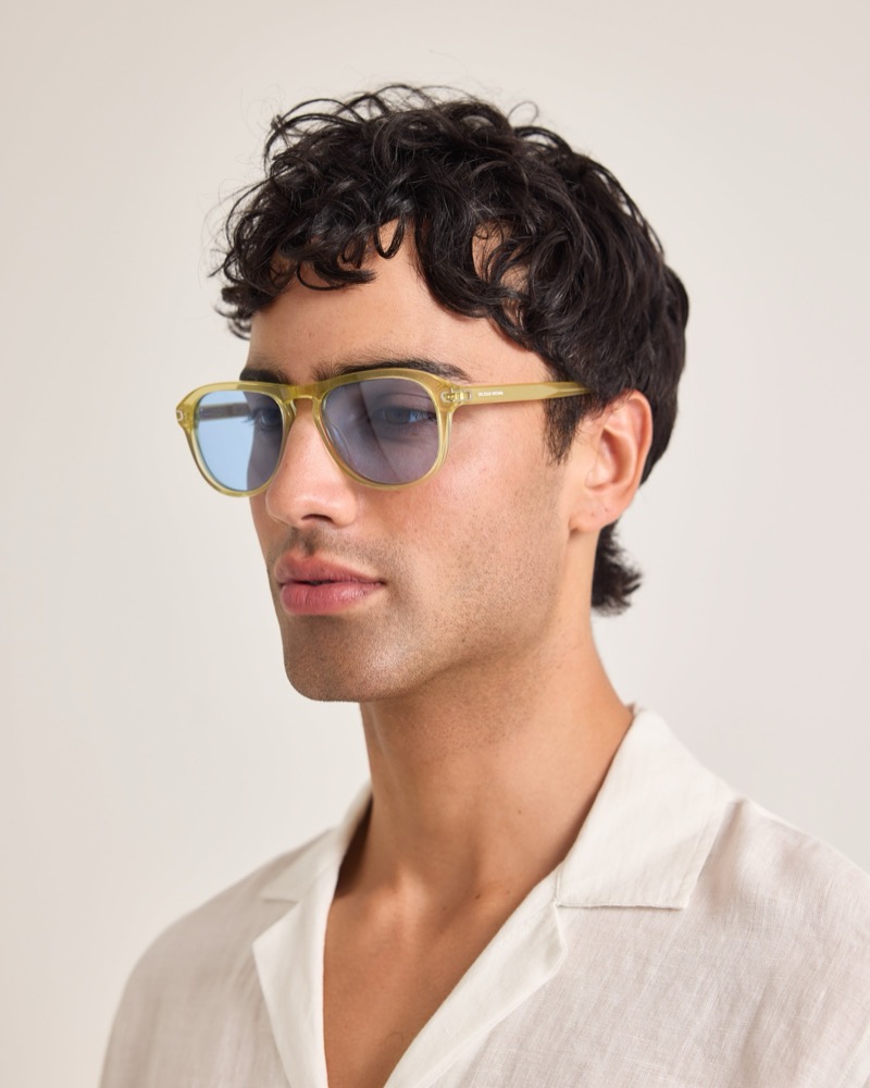 Model wears yellow sunglasses