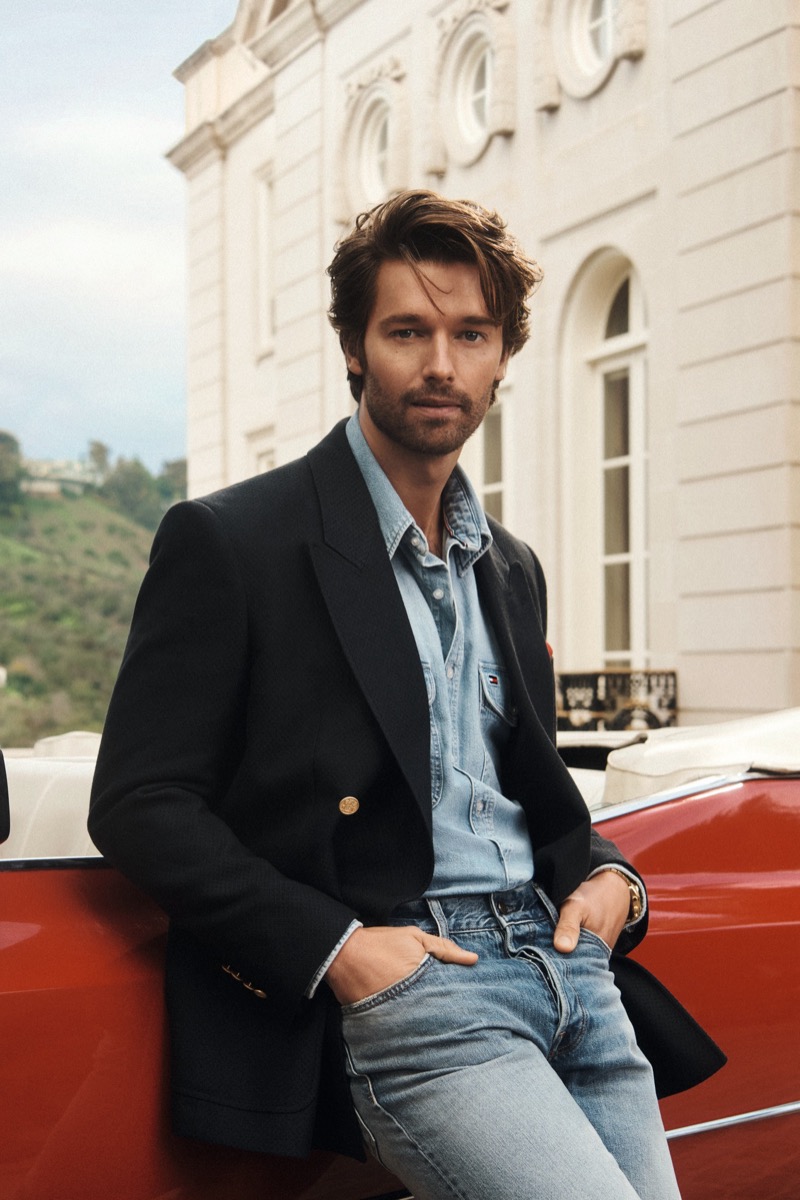 Patrick Schwarzenegger wears a double denim look underneath a navy blazer from Tommy Hilfiger spring 2026