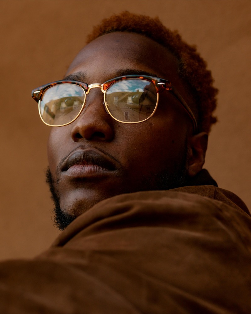 Man wearing browline tortoiseshell sunglasses with a gold lower rim