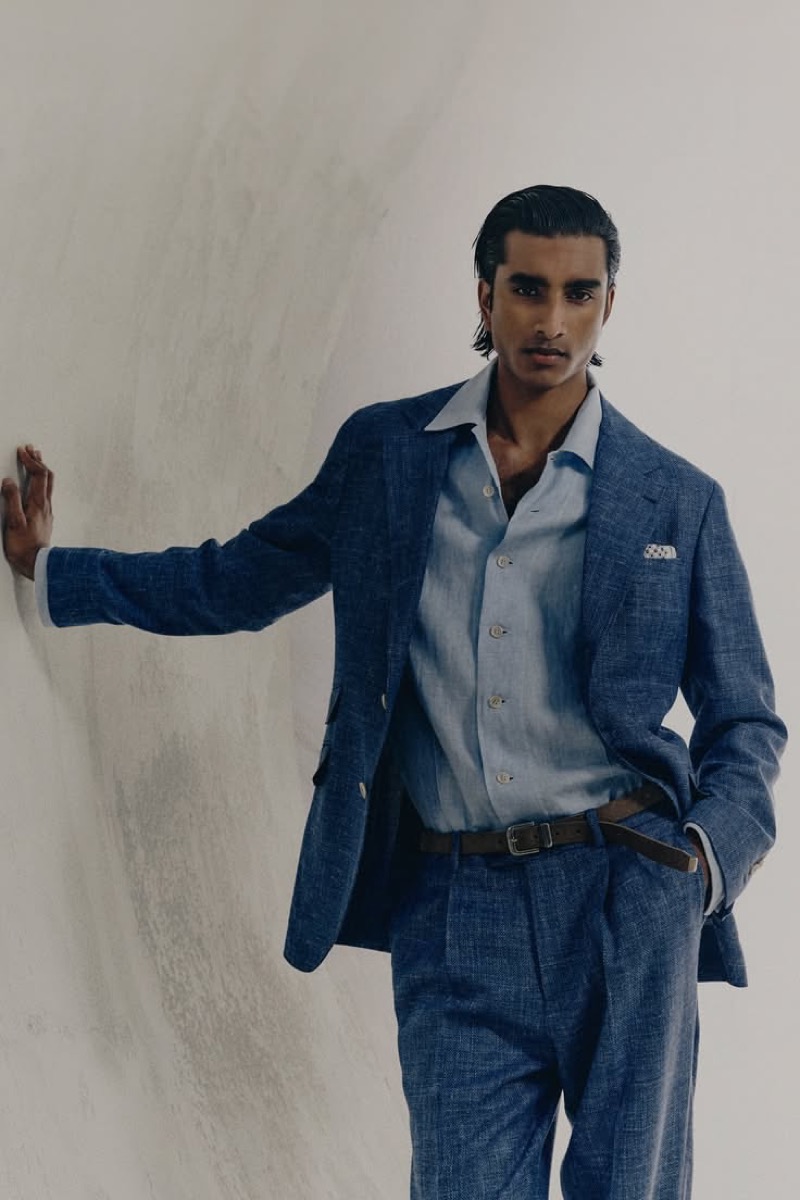 Jeenu wears an air-blue linen suit with a pale shirt open at the collar and a pocket square