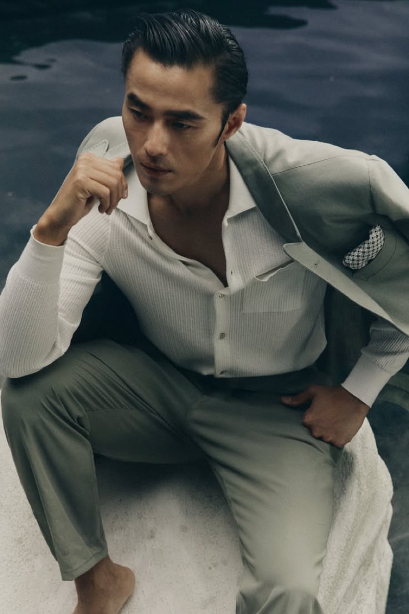 Zhao wears a suit with a white ribbed button-through knit and a pocket square