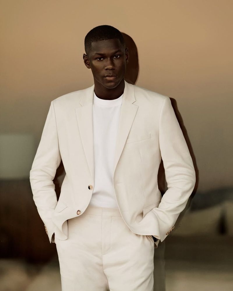 Cheikh wears a cream linen single-breasted suit with a white crewneck T-shirt for Calvin Klein spring 2026