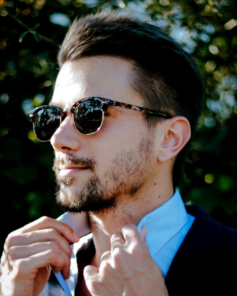 Man wearing clubmaster tortoiseshell sunglasses with a blazer