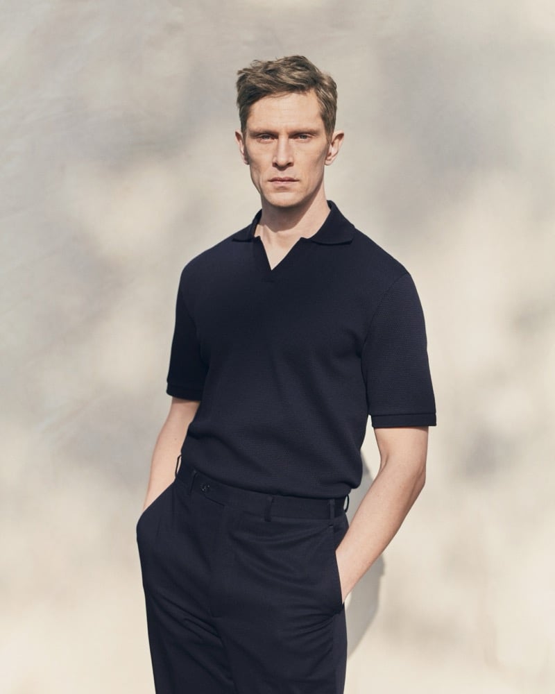 Mathias wears a navy Eton textured polo shirt