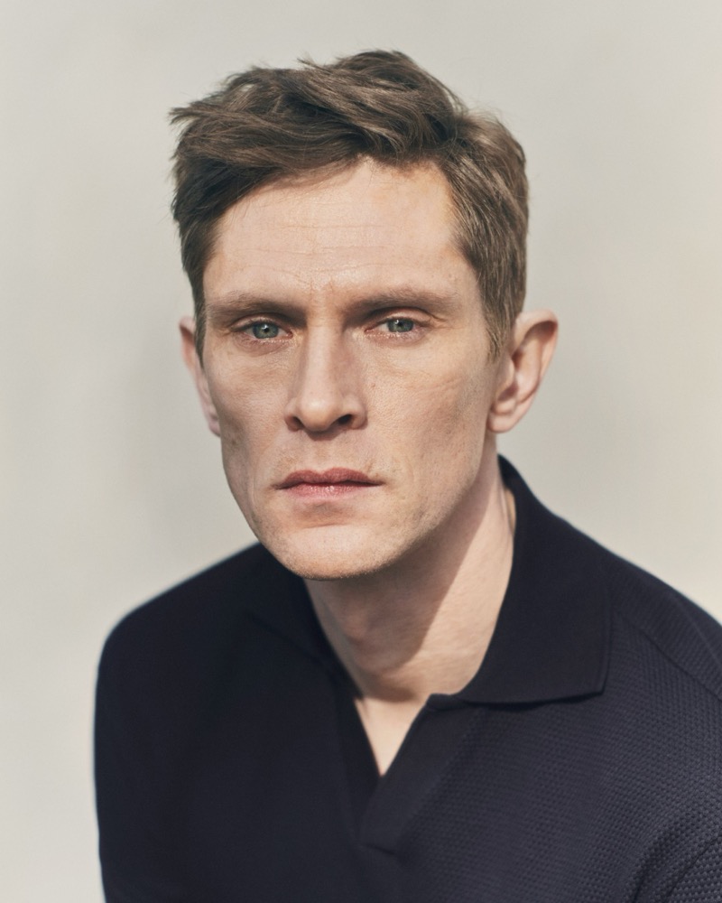 A close-up portrait of Mathias in a navy Eton textured polo