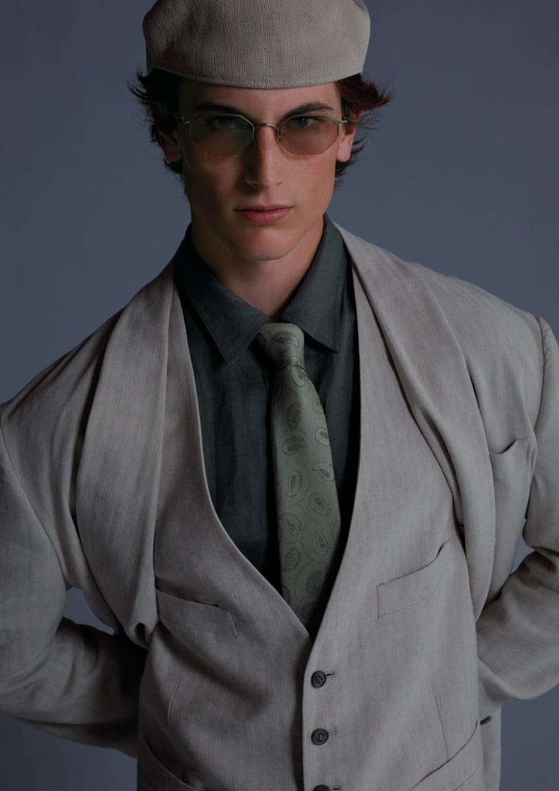 Sean wears a three-piece suit with a shirt, paisley tie, flat cap, and rimless aviator glasses for Giorgio Armani's ARMANI/Archivio 2026 campaign