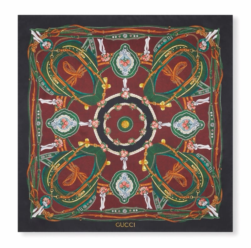 Gucci Art of Silk scarf with swirling green straps, dragonflies, floral medallions, and bells on a burgundy ground