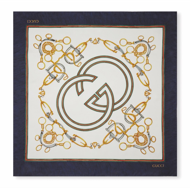 Gucci Art of Silk scarf with an interlocking GG logo surrounded by equestrian hardware on a cream and navy ground