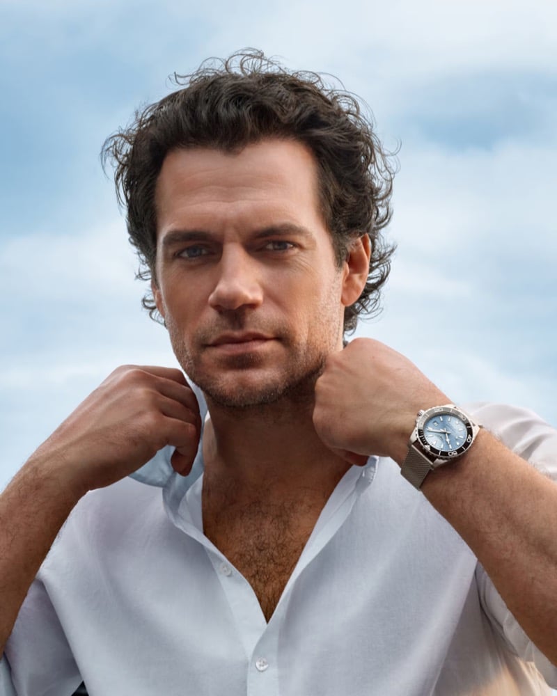 A close-up of Cavill in a white shirt wearing the Longines HydroConquest on Milanese mesh