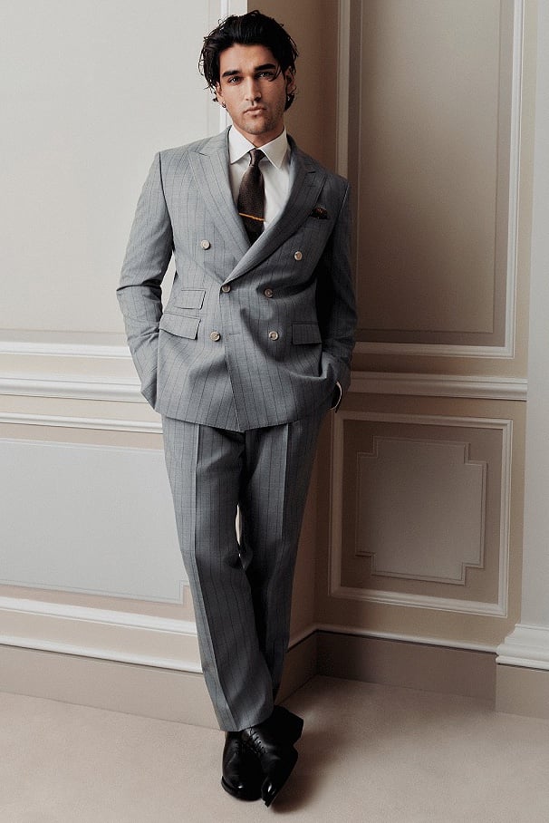 Josh wears a light gray pinstripe BOSS Made to Order double-breasted suit