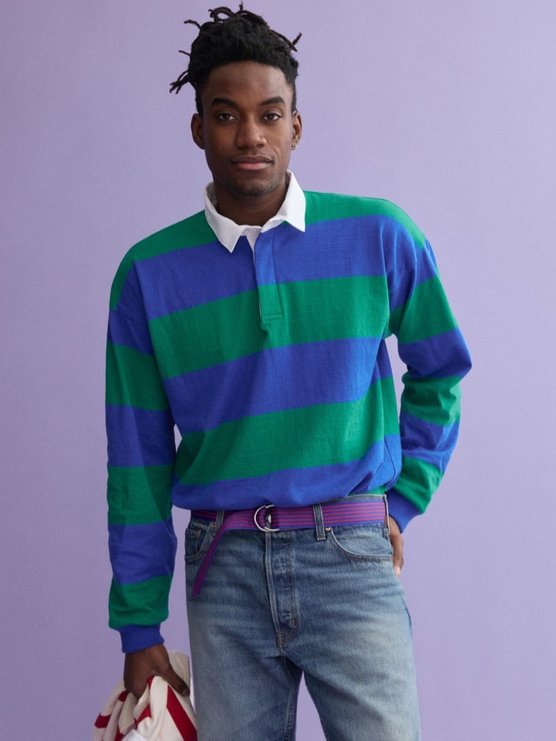 Herzen wears a blue and green block-striped J.Press x Alex Mill rugby shirt with washed denim and a trailing pink and purple D-ring belt