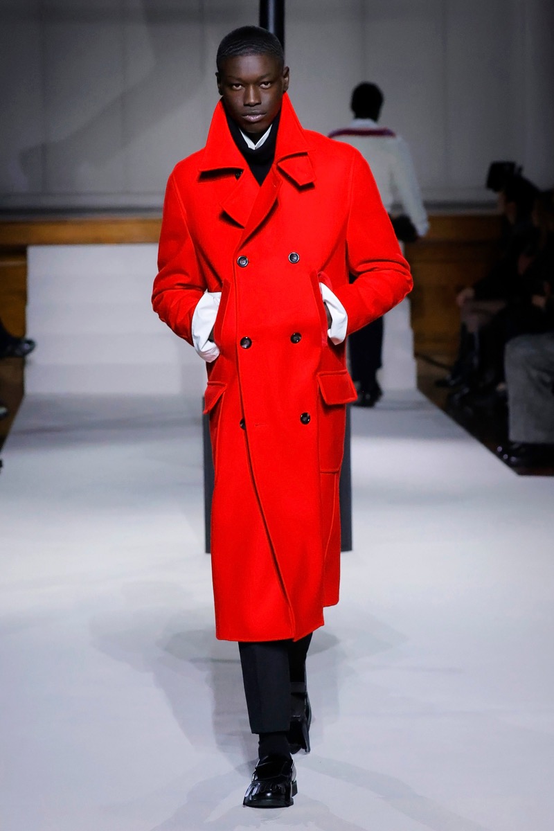 Kent & Curwen fall-winter 2026 red double-breasted wool overcoat over a black turtleneck and white shirt with black trousers
