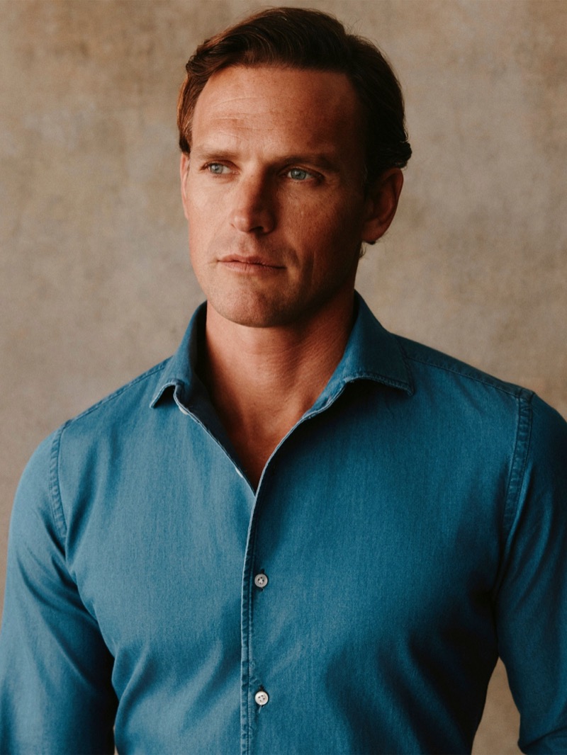 A close-up of Guy in a washed blue denim shirt