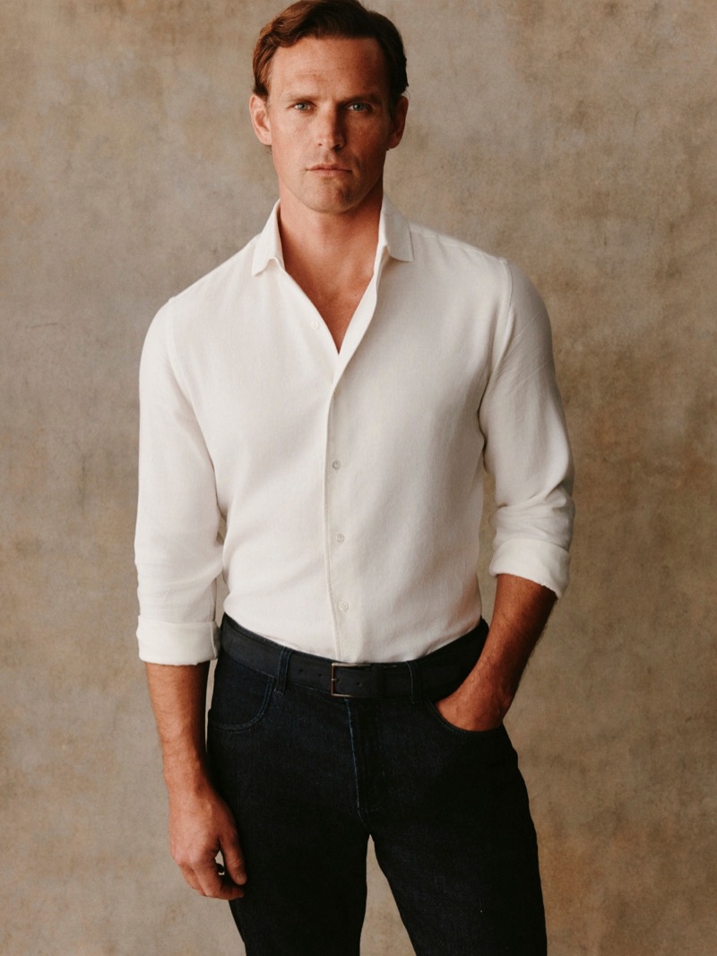 Guy wears a white cotton shirt with dark navy jeans
