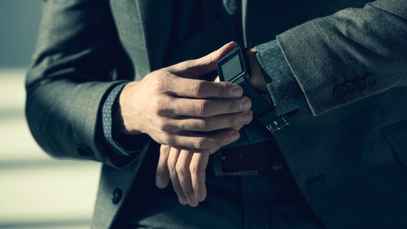 Man in blazer wearing smartwatch with silicone strap
