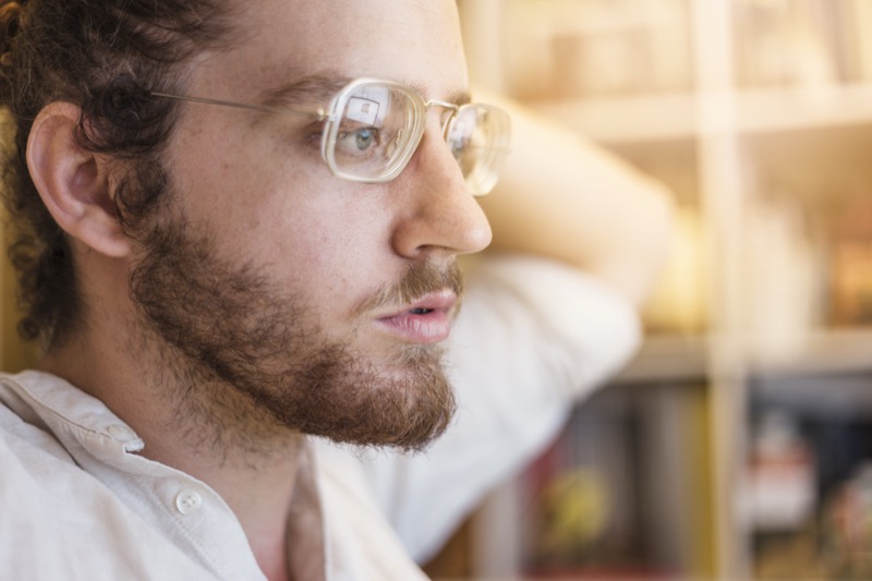 Man wearing clear acetate rectangular glasses