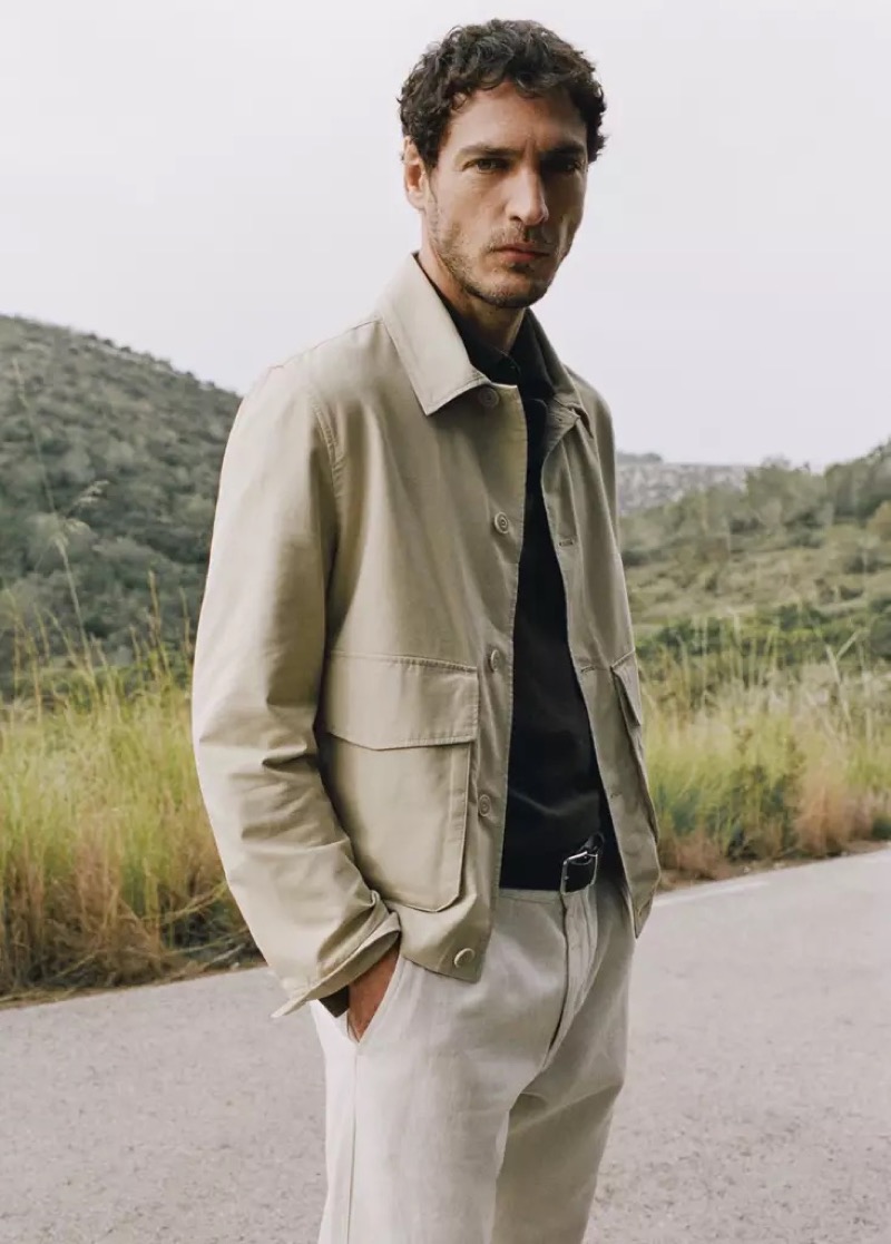 Pierre-Benoit wears a cream jacket over a dark polo with white trousers