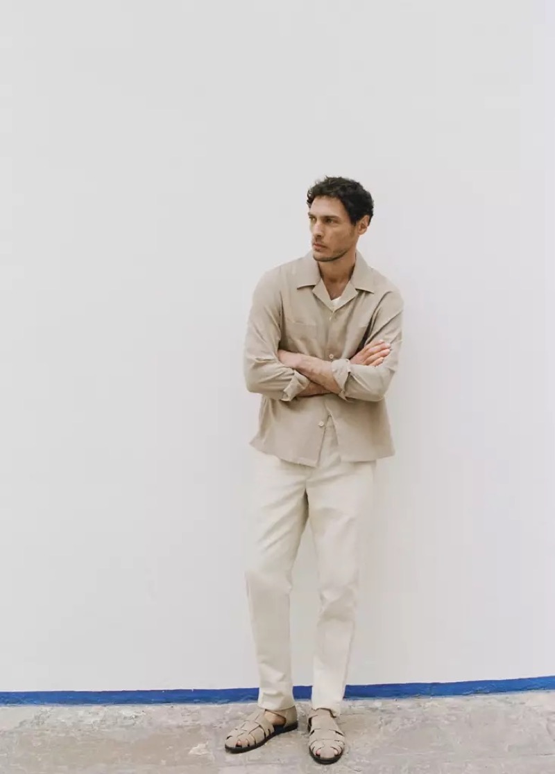 Pierre-Benoit wears a stone camp-collar overshirt with cream trousers and fisherman sandals