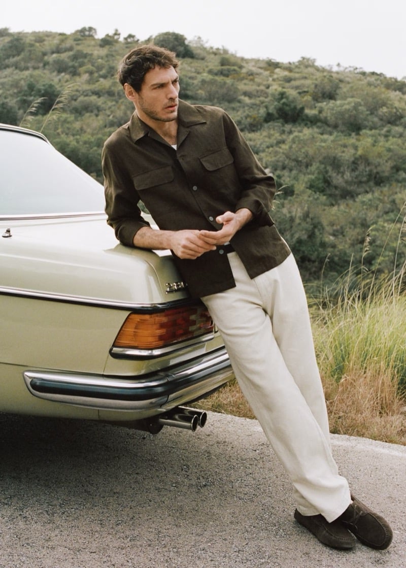 Pierre-Benoit wears a dark cotton-linen overshirt with chest pockets and white trousers