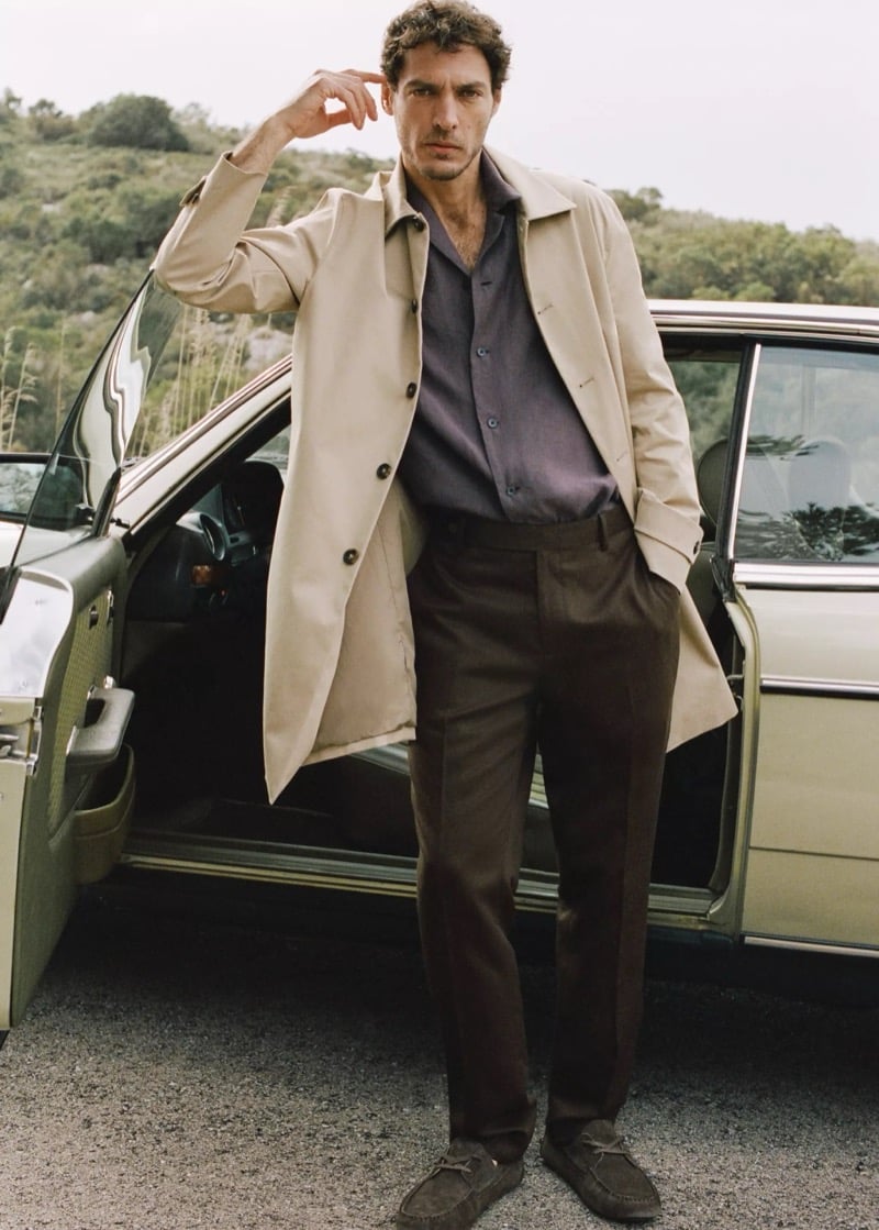 Pierre-Benoit wears a trench coat over a dusky camp-collar shirt with chocolate trousers
